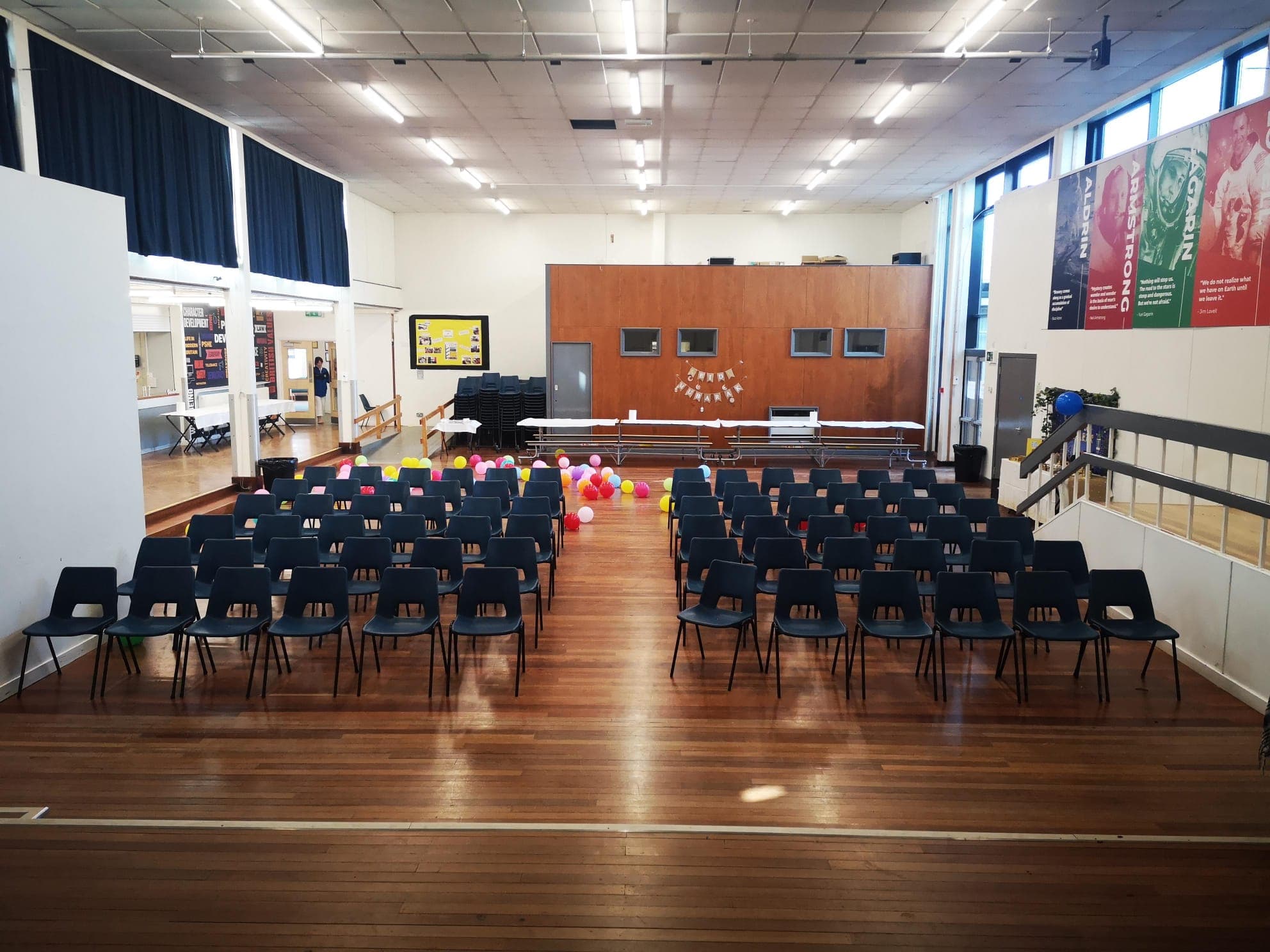 Balloons scattered across the hall floor after celebrations